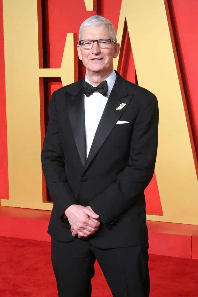 Tim Cook in a classic tuxedo with a bow tie and lapel pin at an event