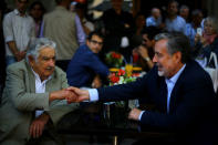 Chilean presidential candidate Alejandro Guillier meets with Uruguayan former president Jose Mujica as part of a campaign rally in Santiago, Chile December 14, 2017. REUTERS/Ivan Alvarado