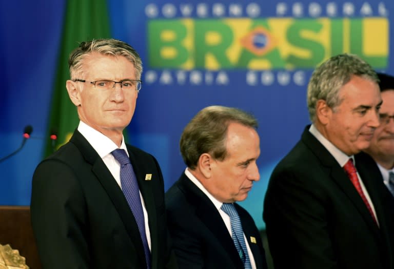 Australian BHP Billiton's chief commercial officer Dean Dalla Valle (L) attends a signing ceremony at the Planalto Palace in Brasilia, on March 2, 2016