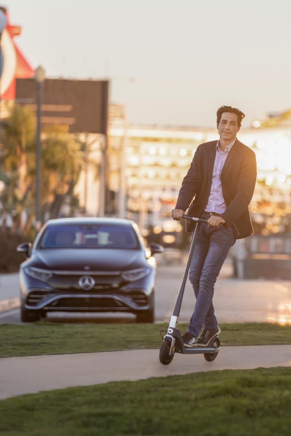 guy on an electric scooter that comes with the eqs580 sedan city edition