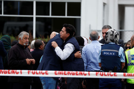 People embrace as they gather for prayers following Friday's shooting outside the Linwood Mosque in Christchurch, New Zealand March 18, 2019. REUTERS/Edgar Su