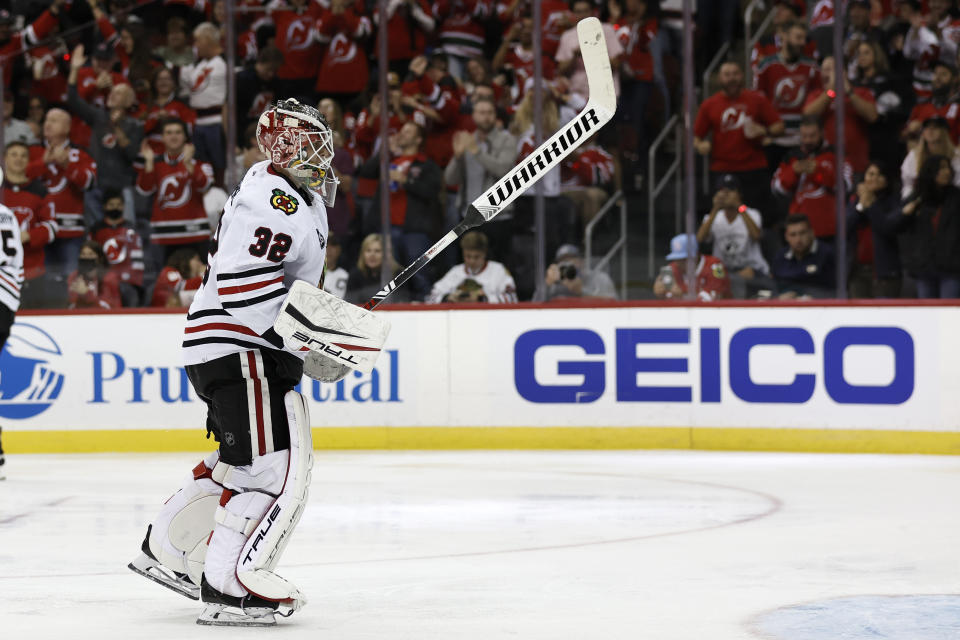 Chicago Blackhawks goaltender Kevin Lankinen reacts after giving up a goal to the New Jersey Devils during the third period of an NHL hockey game Friday, Oct. 15, 2021, in Newark, N.J. (AP Photo/Adam Hunger)