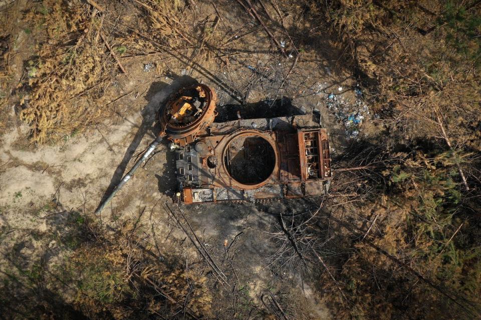 A destroyed Russian tank begins to rust in woodland near Kyiv (Getty Images)