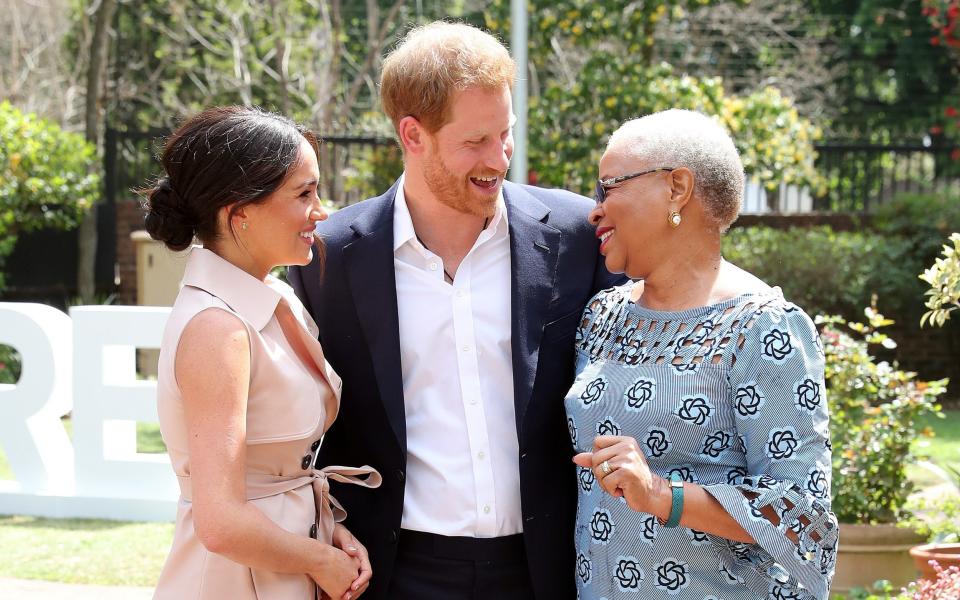 The Duke and Duchess of Sussex meet Graca Machel, the widow of Nelson Mandela, in Johannesburg in October 2019 - Reuters