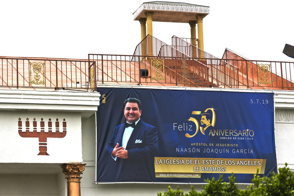 FILE - Mexico-based megachurch La Luz del Mundo, leader and self-proclaimed apostle Naasón Joaquín García's 50 birthday celebration portrait, is displayed on the side of the East Los Angeles temple on Friday, June 7, 2019. García, the leader of the Mexican megachurch La Luz del Mundo, pleaded guilty Friday, June 3, 2022, to sexually abusing three girls, California state prosecutors said. (AP Photo/Damian Dovarganes, File)
