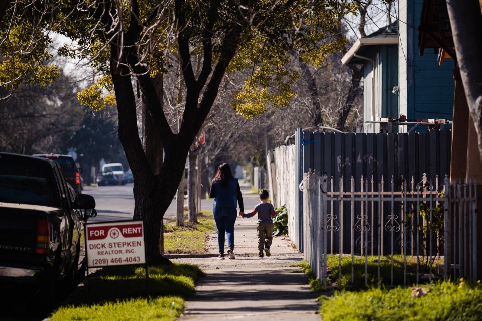 A mother and son walk through one of the neighborhoods of Stockton, California on Feb. 7, 2020. The city recently finished a two year basic income trial.  (Photo: NICK OTTO via Getty Images)