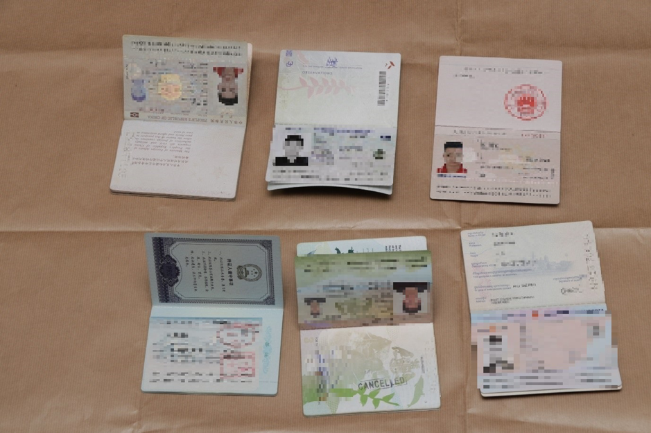 Diverse Array: Passports believed to be from various nationalities seized by the Police