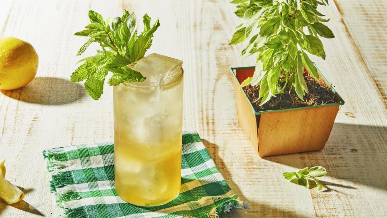 a glass of lemonade with a lemon slice and a lemon slice