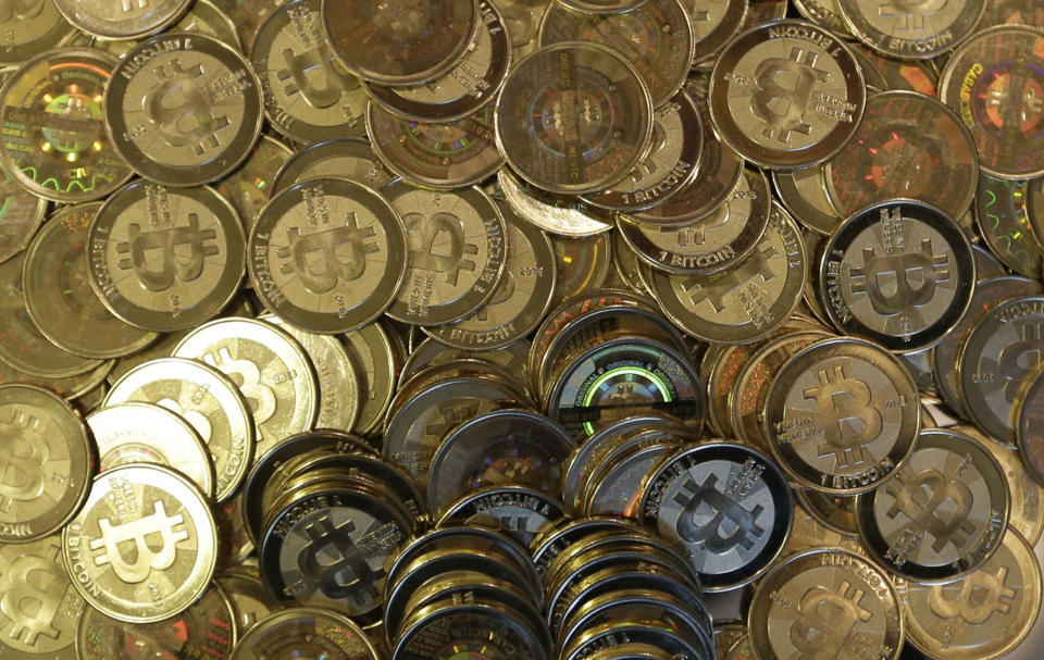 FILE - This April 3, 2013 file photo shows bitcoin tokens in Sandy, Utah. The Tokyo bitcoin exchange Mt. Gox that filed for bankruptcy protection blamed theft through hacking for its losses Monday, March 3, 2014, and said it was looking into a criminal complaint. (AP Photo/Rick Bowmer, File)