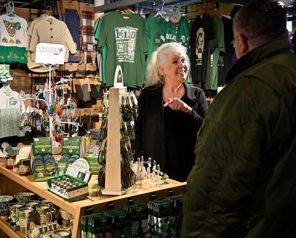 Jennifer Courville, owner of Erin Giftstore at Worcester Public Market, talks with a customer.