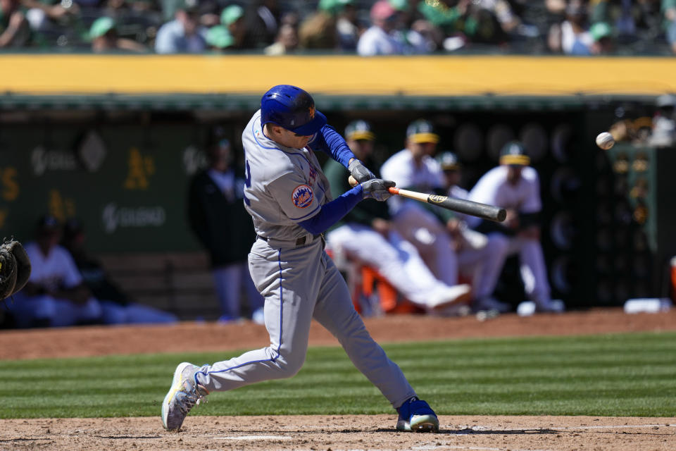 New York Mets' Mark Canha hits a solo home run against the Oakland Athletics during the seventh inning of a baseball game in Oakland, Calif., Saturday, April 15, 2023. (AP Photo/Godofredo A. Vásquez)