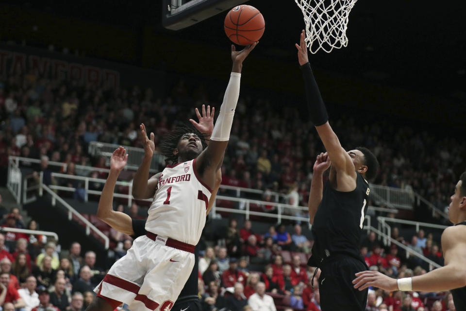 Stanford guard Daejon Davis (1) shoots against Colorado guard Tyler Bey (1) during the first half of an NCAA college basketball game in Stanford, Calif., Sunday, March 1, 2020. (AP Photo/Jed Jacobsohn)