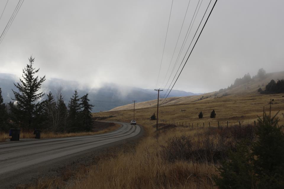 A vehicle moves down a roar at the Joe Rich community located outside of Kelowna, British Columbia, on Dec. 7, 2023. The community is in close proximity to a cherry orchard expansion site near a key wildlife corridor that ribbons around the Okanagan Mountain Provincial Park and Kalamalka Lake Provincial Park. (Aaron Hemens/IndigiNews via AP)