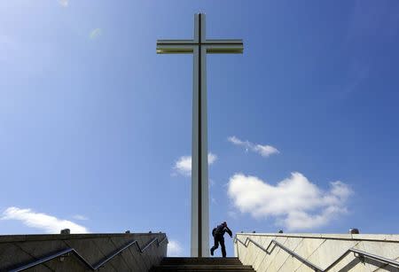 A man climbs the steps to the Papal Cross in Phoenix Park in Dublin in Ireland May 21, 2015. REUTERS/Cathal McNaughton