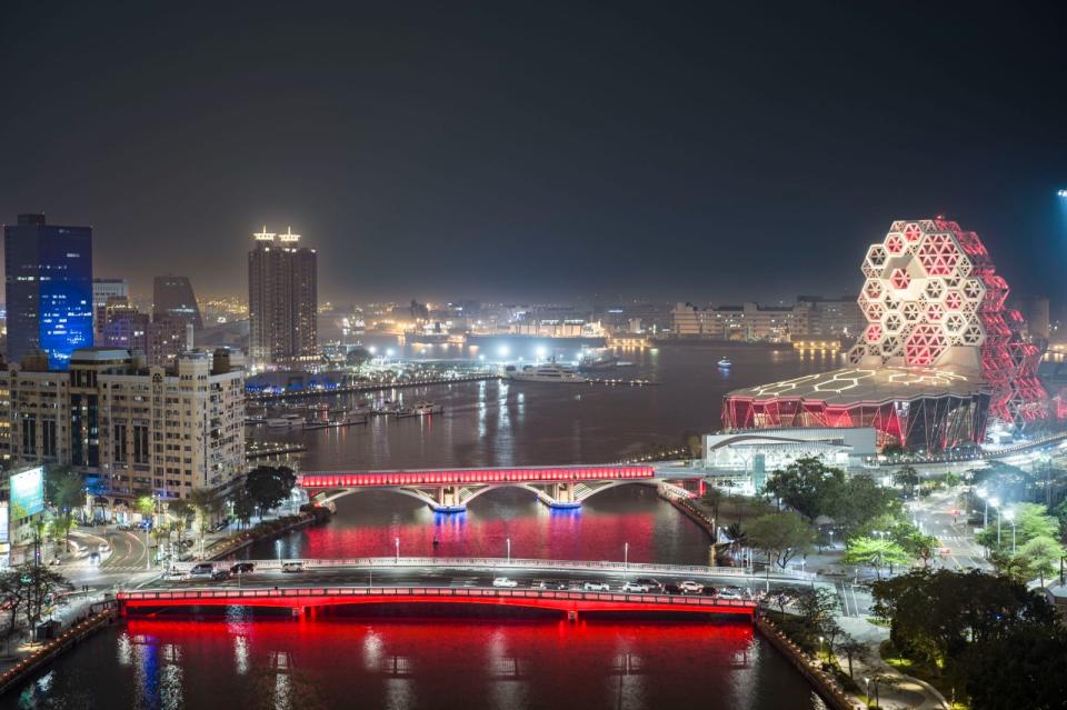 高雄流行音樂中心及愛河多座橋體點亮紅光響應著紅日。高市府提供