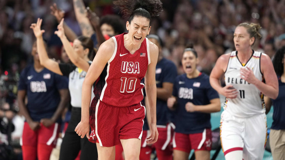 United States' Breanna Stewart, center, celebrates after scoring as Belgium's Emma Meesseman, right, runs along during a women's basketball game at the 2024 Summer Olympics, Thursday, Aug. 1, 2024, in Villeneuve-d'Ascq, France. (AP Photo/Michael Conroy)