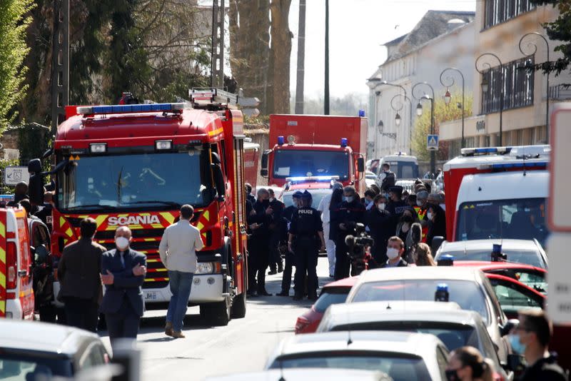 Police secure the area where an attacker stabbed a woman, in Rambouillet