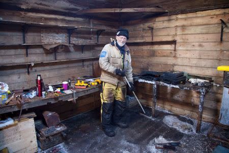 Mawson's Huts expedition conservator Peter Maxwell stands in the workshop section of Mawson's Hut at Cape Denison in Antarctica in this January 4, 2016 handout photo. REUTERS/David Killick/Mawsons Huts Foundation/Handout via Reuters