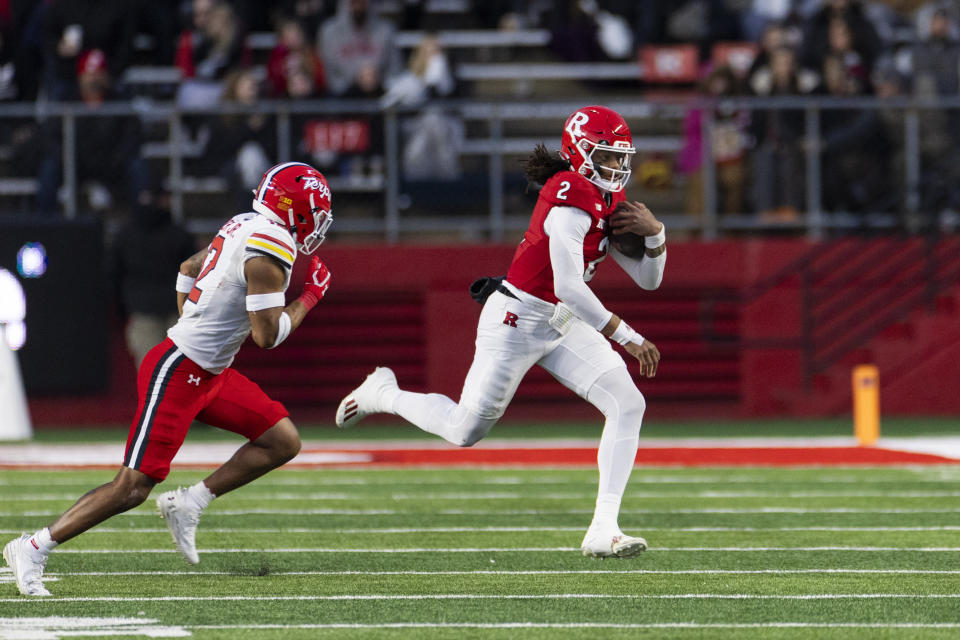 Rutgers quarterback Gavin Wimsatt (2) runs the ball while pursued by Maryland defensive back Dante Trader Jr. (12) in the first half of an NCAA college football game, Saturday, Nov. 25, 2023, in Piscataway, N.J. (AP Photo/Corey Sipkin)