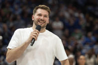 Dallas Mavericks' Luka Doncic acknowledges the crowd before an NBA basketball game against the Detroit Pistons, Friday, April 12, 2024, in Dallas. Doncic was not going to play due to left ankle soreness (AP Photo/Jeffrey McWhorter)