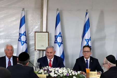 Israeli Prime Minister Benjamin Netanyahu sits next to U.S. Ambassador to Israel David Friedman as he holds a special cabinet meeting in the Israeli-occupied Golan Heights