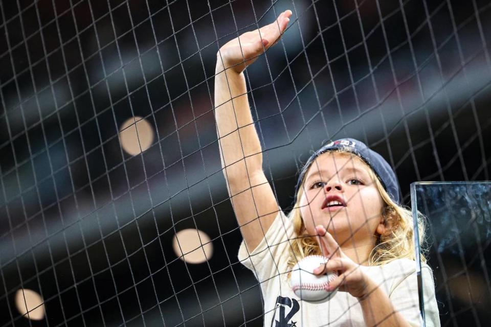 A young fan calls out to the Texas Rangers players prior to a a regular season match up against the Los Angeles Dodgers at Globe Life Field in Arlington, Texas on Saturday, July 22, 2023. The Rangers gave up 18 hits and lost 16-3.