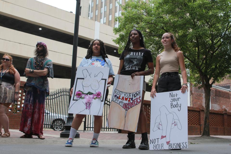 [From left] Vanessa Grove, Faith Powell, and Sarah Murrah hold signs during the Reproductive Rights Protesting, Augusta rally Saturday, May 21, 2022, at the Augusta Common.
