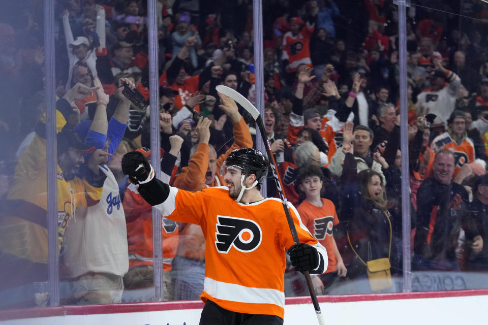 Philadelphia Flyers' Noah Cates celebrates with fans after scoring a goal during the second period of an NHL hockey game against the Detroit Red Wings, Sunday, March 5, 2023, in Philadelphia. (AP Photo/Matt Slocum)