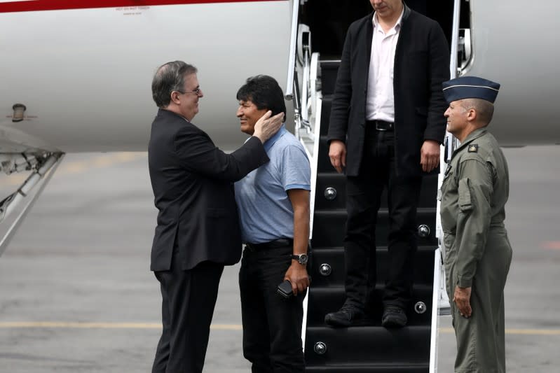 Bolivia's ousted President Evo Morales is welcomed by Mexico's Foreign Minister Marcelo Ebrard during his arrival to take asylum in Mexico, in Mexico City