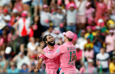 Cricket - South Africa v Sri Lanka - Third One Day International cricket match - Wanderers Stadium, Johannesburg, South Africa - 4/2/17 - South Africa's bowler Imran Tahir is congratulated by his captain AB de Villiers after Tahir bowled out Sri Lanka's batsman Sachith Pathirana. REUTERS/Siphiwe Sibeko