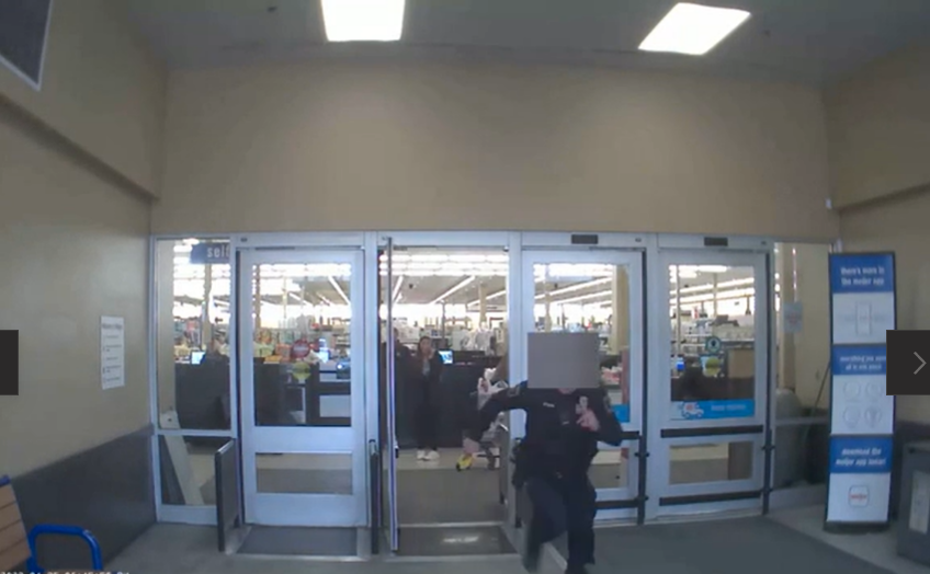 An East Lansing police officer runs with a stun gun while chasing a 20-year-old out of Meijer at 1350 W. Lake Lansing Road in East Lansing on April 25, 2022.