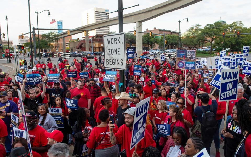 Members of the United Auto Workers (UAW) union march through the streets of downtown Detroit