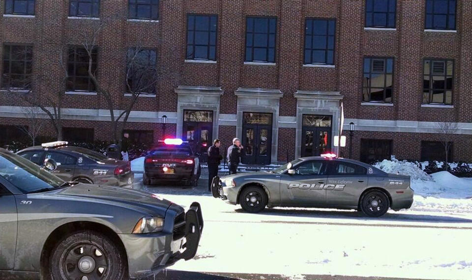 Police investigate reports of a shooting at Purdue University in West Lafayette, Ind., on Tuesday, Jan. 21, 2014. Police say they have a person in custody and the university says it told people to take shelter and have cleared the building as the area is searched. (AP Photo/The Journal & Courier, John Terhune)