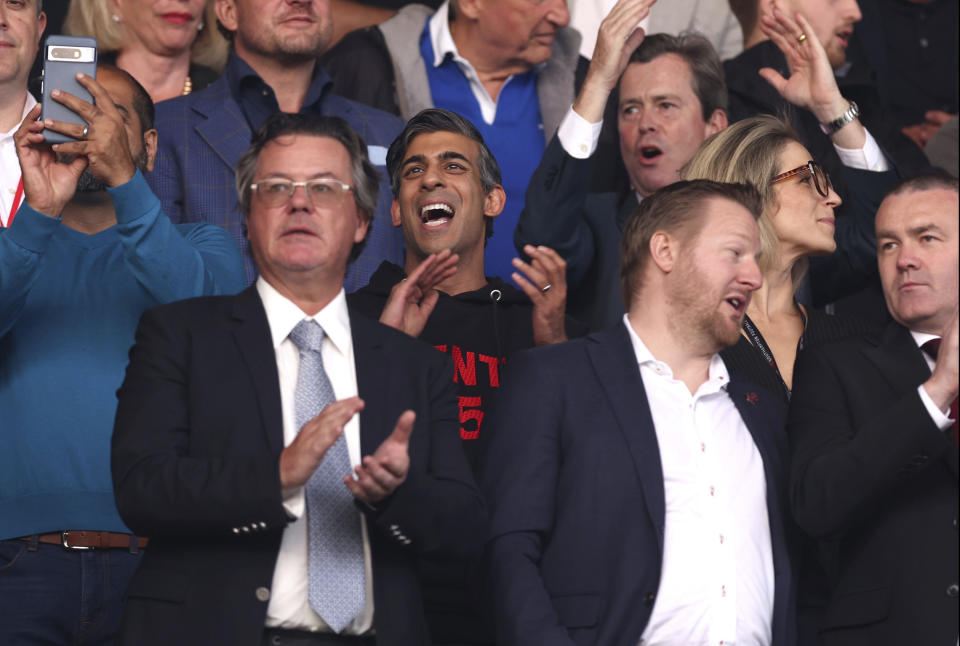 Britain's Prime Minister Rishi Sunak gestures in the stands during the Sky Bet Championship play-off, semi-final, second leg match between West Bromwich Albion and Southampton at St Mary's Stadium in Southampton, Friday May 17, 2024. (Steven Paston/PA via AP)