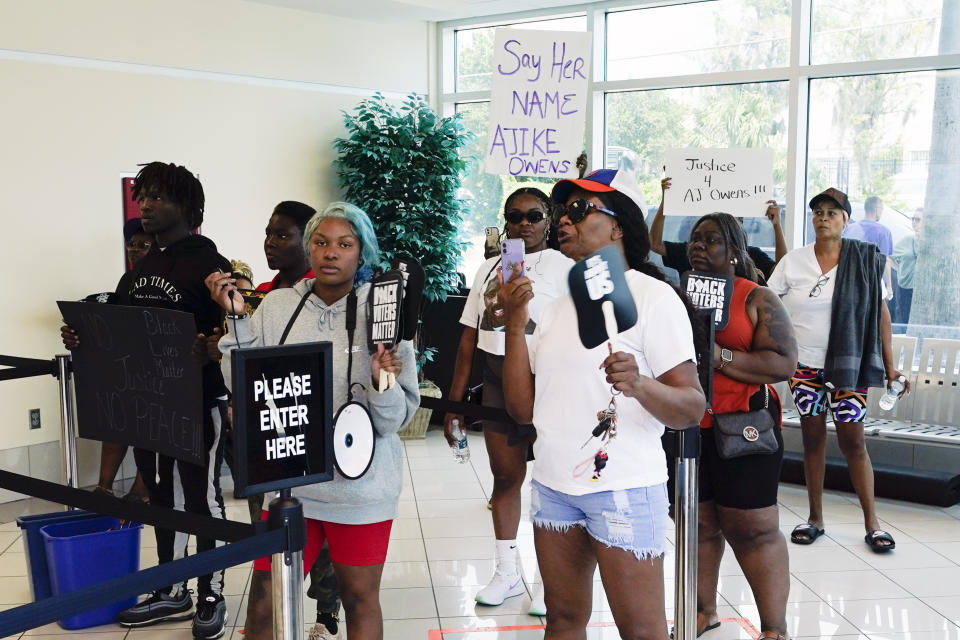 Protesters gather in the lobby of the Marion County Courthouse, Tuesday, June 6, 2023, in Ocala, demanding the arrest of a woman who shot and killed Ajike Owens, a 35-year-old mother of four, last Friday night, June 2. Authorities came under intense pressure Tuesday to bring charges against a white woman who killed Owens, a Black neighbor, on her front doorstep, as they navigated Florida’s divisive stand your ground law that provides considerable leeway to the suspect in making a claim of self defense. (AP Photo/John Raoux)