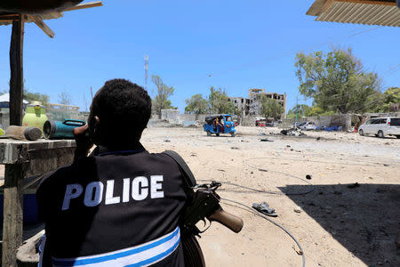 A Somali policeman holds position as al-Shabaab militia storms a government building in Mogadishu, Somalia March 23, 2019. REUTERS/Feisal Omar