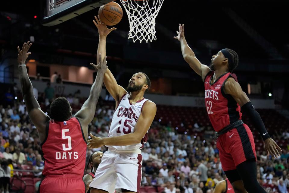 Cleveland Cavaliers forward Isaiah Mobley, center, shoots against Houston Rockets' Darius Days, left, and Nate Hinton during the first half of the NBA summer league championship game July 17 in Las Vegas.