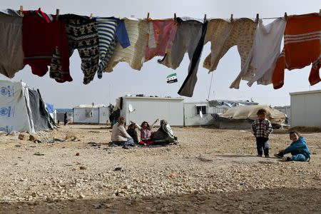 Syrian refugee women sit in front of their tents at the Al Zaatri refugee camp, in the Jordanian city of Mafraq, near the border with Syria, January 18, 2016. REUTERS/Muhammad Hamed