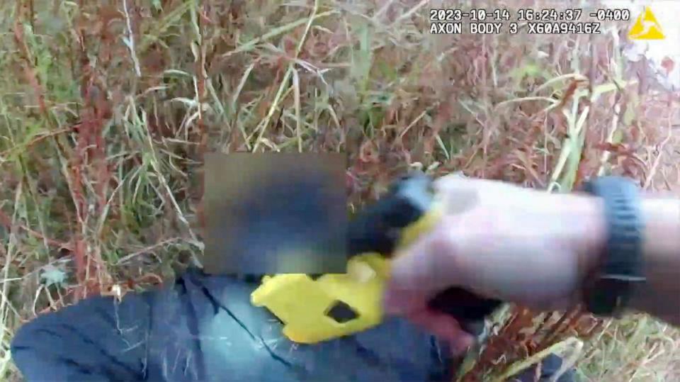 PHOTO: This frame grab from Naugatuck, Conn., Police Department body camera video, with parts of the video blurred by the source, shows Officer Kehoss pulling a stun gun trigger as he yells at a shoplifting suspect during an arrest, Oct. 14, 2023. (AP)