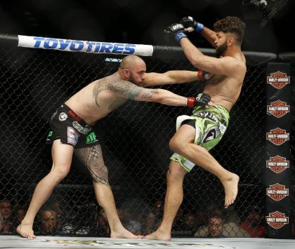 Andrei Arlovski (R) and Travis Browne engage during their heavyweight fight. (AP)