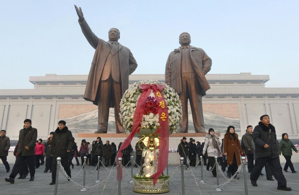 North Koreans offer flowers to bronze statues of North Korea's late founder Kim Il Sung and late leader Kim Jong Il at Mansudae in Pyongyang