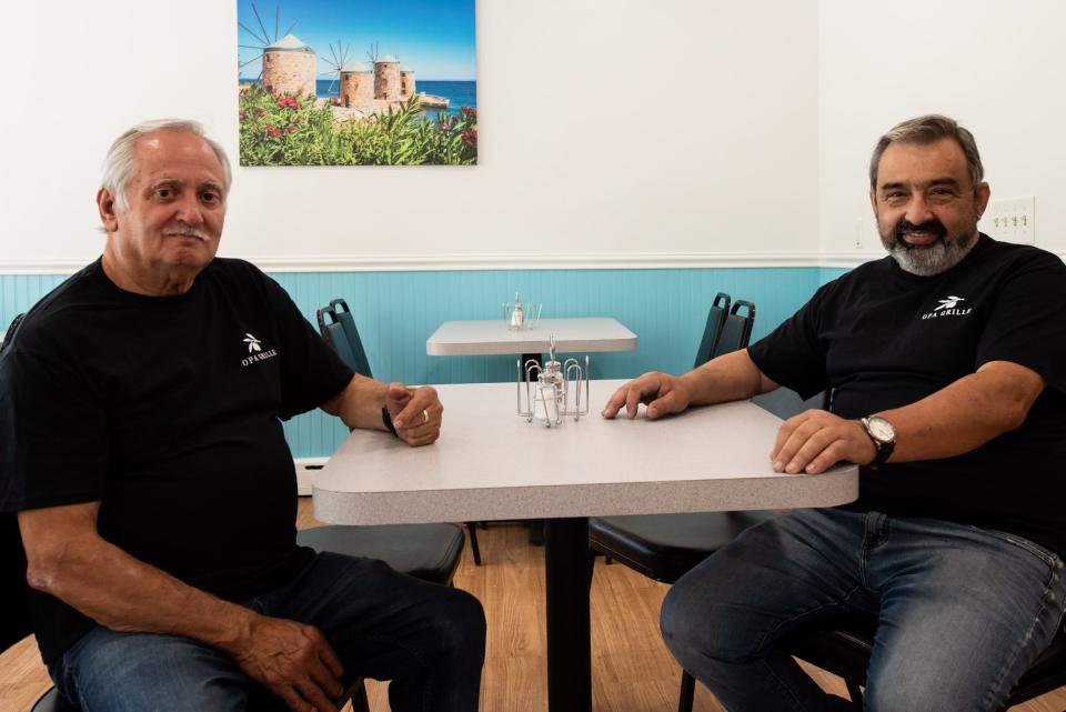 Jimmy Giannoumis, left, and Gus Mamounas, owners of Opa Grille, sit inside their new restaurant, Friday, September 1, 2023, days before their grand opening.