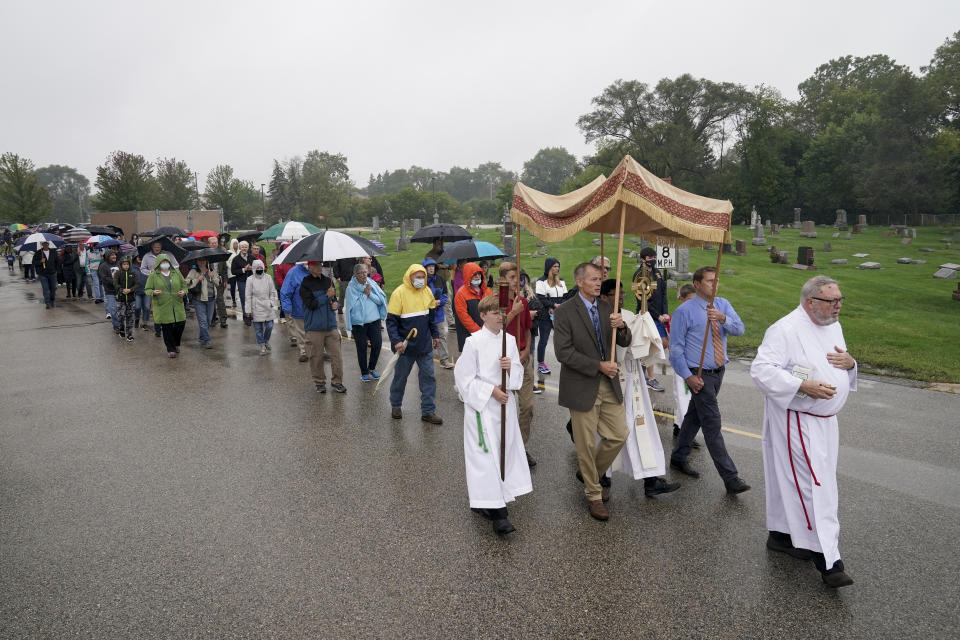 Churchgoers participate in a procession at the Holy Apostles Church in Milwaukee, Saturday, Sept. 12, 2020. For decades, Roman Catholic voters have been a pivotal swing vote in U.S. presidential elections, with a majority backing the winner — whether Republican or Democrat — nearly every time. (AP Photo/Morry Gash)