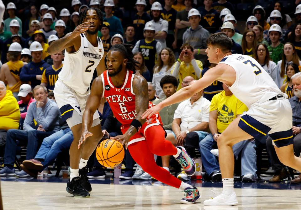 Joe Toussaint of Texas Tech drives against Kerr Kriisa of West Virginia in the first half at the WVU Coliseum on Saturday, March 2, 2024 in Morgantown, West Virginia.