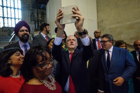 Britain's opposition Labour Party leader Jeremy Corbyn takes a selfie with Labour MPs in Westminster Hall in the Houses of Parliament in London, Britain, June 28, 2017. REUTERS/Jack Taylor/Pool