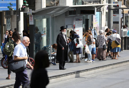 An ultra-Orthodox Jewish man stands near tracks of the light rail in Jerusalem October 18, 2018. REUTERS/Ammar Awad