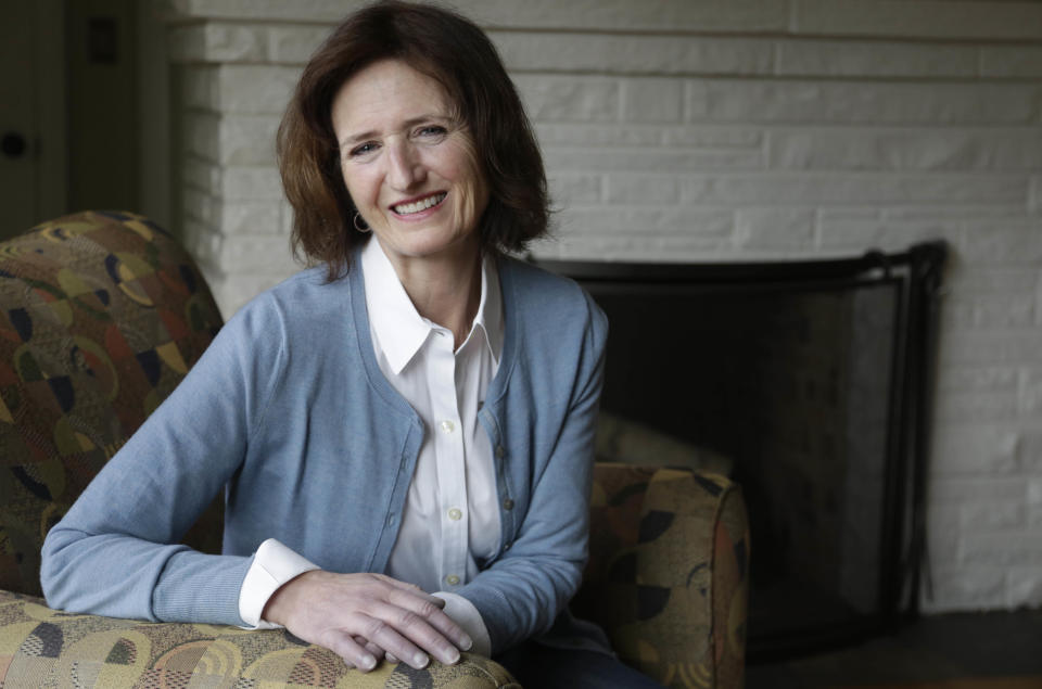 In this Feb. 1, 2017, photo, Mary Clauss poses for a photo at her home in Glen Ellyn, Ill. Donald Trump's presidency has led to passionate protests around the country that have swelled the ranks of Democratic activists. Among the newly energized activists is Clauss, had long voted Democratic but had never gotten involved in campaigns nor had she protested anything since her college days. Clauss has been regularly sending postcards and making phone calls to her congressional delegation expressing concerns about Trump's policies and cabinet nominees. (AP Photo/M. Spencer Green)