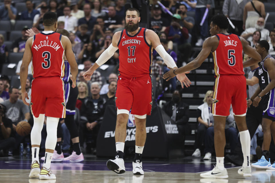 New Orleans Pelicans center Jonas Valanciunas (17) greets guards CJ McCollum (3) and Herbert Jones (5) during the first half of the team's NBA basketball game against the Sacramento Kings on Thursday, April 11, 2024, in Sacramento, Calif. (AP Photo/Benjamin Fanjoy)