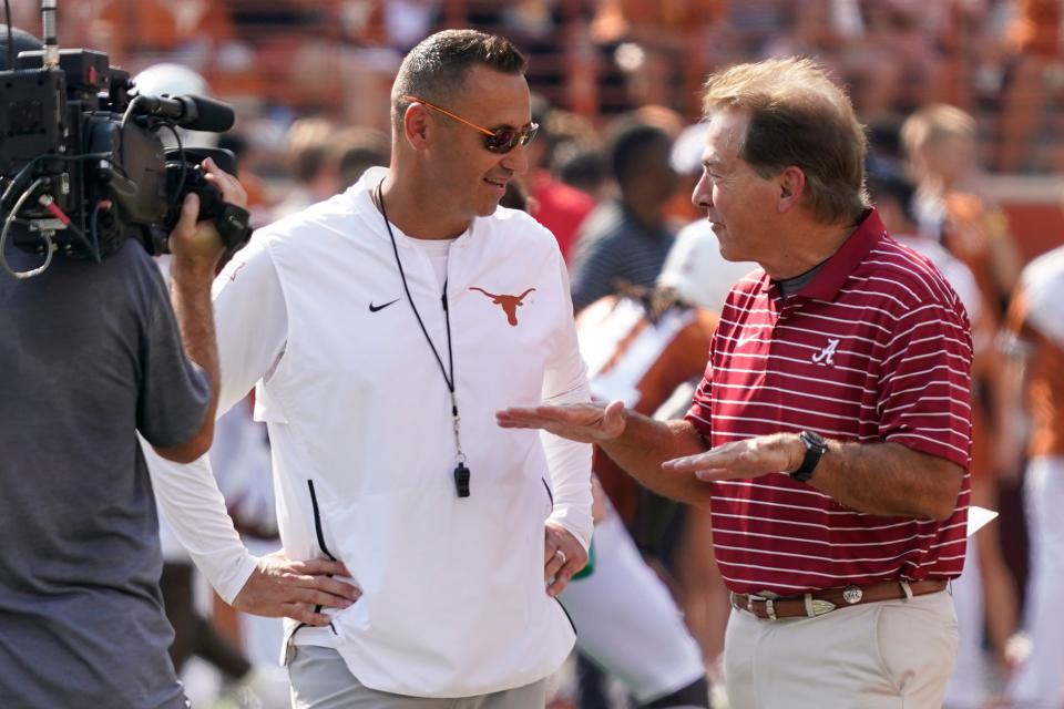 Longhorns head coach Steve Sarkisian talks with Alabama Crimson Tide head coach Nick Saban before the game at Royal-Memorial Stadium last weekend.