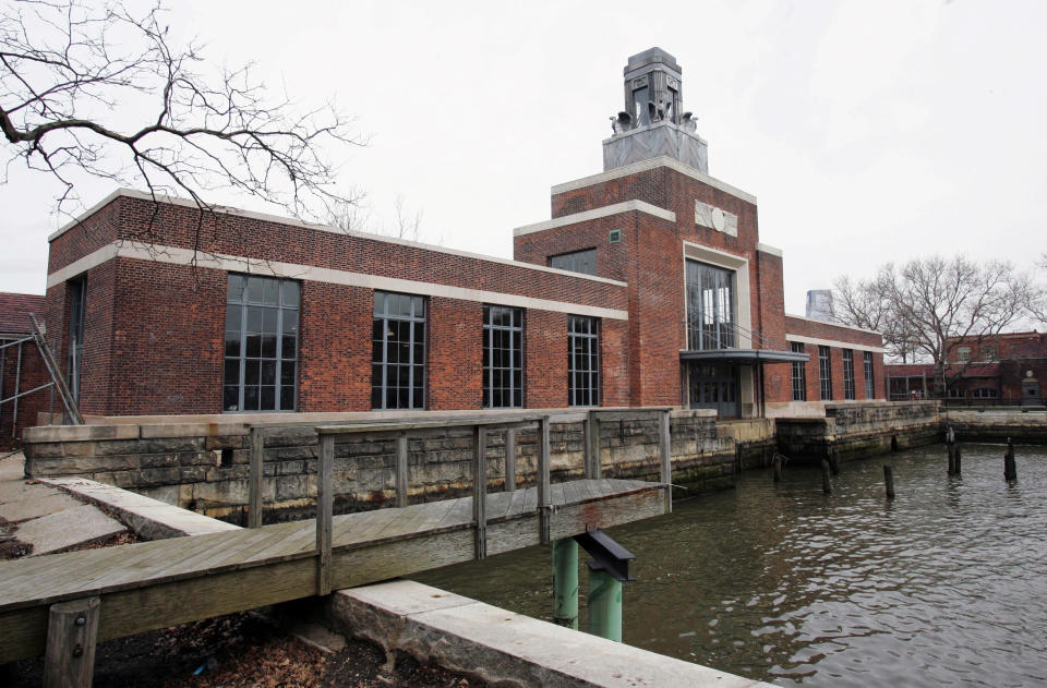 FILE - This March 26, 2007 file photo shows the ferry building on Ellis Island, N.J. The National Parks Service says the Ellis Island Immigration Museum will reopen to the public on Monday, Oct. 28, 2013. It's been about a year since Superstorm Sandy brought water levels as high as 8 feet to the iconic former U.S. immigration entry point. (AP Photo/Mike Derer, File)